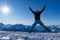 Girl with goggles and helmet is leaping midair in winter