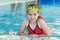 Girl with goggles in swimming pool