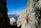 Girl going the mountain via ferrata in Dolomite Alps