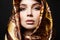 Girl in a gold scarf. beautiful young woman in colorful veil