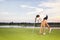 Girl golf player picking up ball from cup.