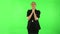 Girl got a cold, sore throat and head, cough on green screen at studio