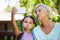 Girl and grandmother making faces while taking selfie