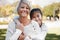 Girl, grandmother and portrait with happiness in the outdoor on the weekend in nature. Kid, grandma and hug in summer