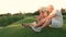 Girl and grandparents sitting on grass.