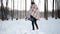 Girl in gray coat on a bridge in winter