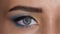 Girl with gray eyes and languid eyes looking into the distance and blinks. Close up