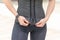 Girl in gray sports leggings unbutton corset