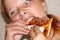 Girl greedily eating pizza close up