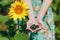 Girl in green dress holds sunflower seeds in hands