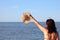 Girl greets with boater in summer and the ocean in background