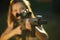 Girl with a gun for trap shooting aiming at a target