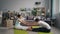 Girl and guy doing yoga stretching arms, legs and back at home sitting on mats