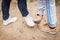 A girl and a guy greet each other with their feet