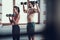 Girl And Guy In Gym Doing Dumbbells Exercises