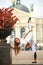 Girl gymnast doing stretching exercise on square of tourist town