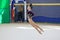Girl gymnast performs an element of the Scissors backbone.