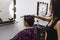 The girl hairdresser carefully makes a hairstyle for her client