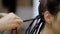 Girl hairdresser weaves dreadlocks client in the salon