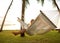 Girl in a hammock bother palm trees enjoying a tropical vacation