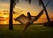 Girl in a hammock bother palm trees enjoying a tropical vacation