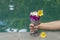 Girl hand holding a glass with hia seeds pudding on the background of the swimming pool water . Chia seeds pudding with red dragon