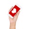 Girl hand holding mobile phone display heart on red screen