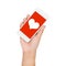 Girl hand holding mobile phone display heart on red screen