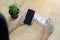 Girl hands connecting charger to her smart phone in a table at home with white extension plug