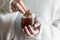 Girl hands dipping cookie in hot tea