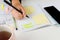 Girl Hands With Mobile Phone With Calendar Writing And List Of Work In Diary On Desk