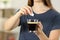 Girl hands throwing a sugar cube into a coffee cup