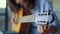 Girl hands tuning guitar. Young woman checking pegs of acoustic guitar