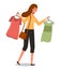 Girl with a hangers with t-shirts in her hands goes shopping. Buyer is selecting clothes in a store