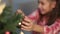 Girl hanging decorative toy ball on Christmas tree