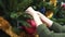 Girl hanging decorative toy ball on Christmas tree branch