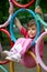 Girl hanging on rings a children\'s playground