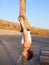 Girl hanging upside down on gymnastics rings