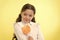 Girl happy face holds sweet lollipop ok gesture. She deserved candy. Girl likes sweet candy yellow background