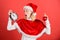 Girl happy wear santa costume celebrate christmas hold ball decor red background. Christmas preparation concept