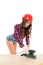 girl in hardhat working with grind tool at wooden table,