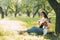 A girl in harmony with herself plays the guitar in the park. Hobbies, music, musician