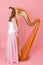 Girl with a harp on a pink background