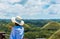 Girl in hat on the background of the Chocolate hills, Bohol island, Philippines. With selective focus