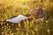 The girl in a hat dremet among wildflowers