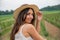 Girl with hat gets photographed in the countryside amid vineyards. Vineyard concept