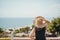 Girl in a hat looks at the Turkish seascape of Antalya in the summer. Travel in Turkey, vacation, enjoyment concept.