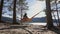 Girl in a hat is resting in an orange hammock. beautiful view of the near the river in a pine forest