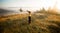 Girl with hat run with happiness on top of a mountain in autumn sunrise