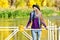 Girl in hat standing on the dock and enjoy the weather. Sunny Autumn